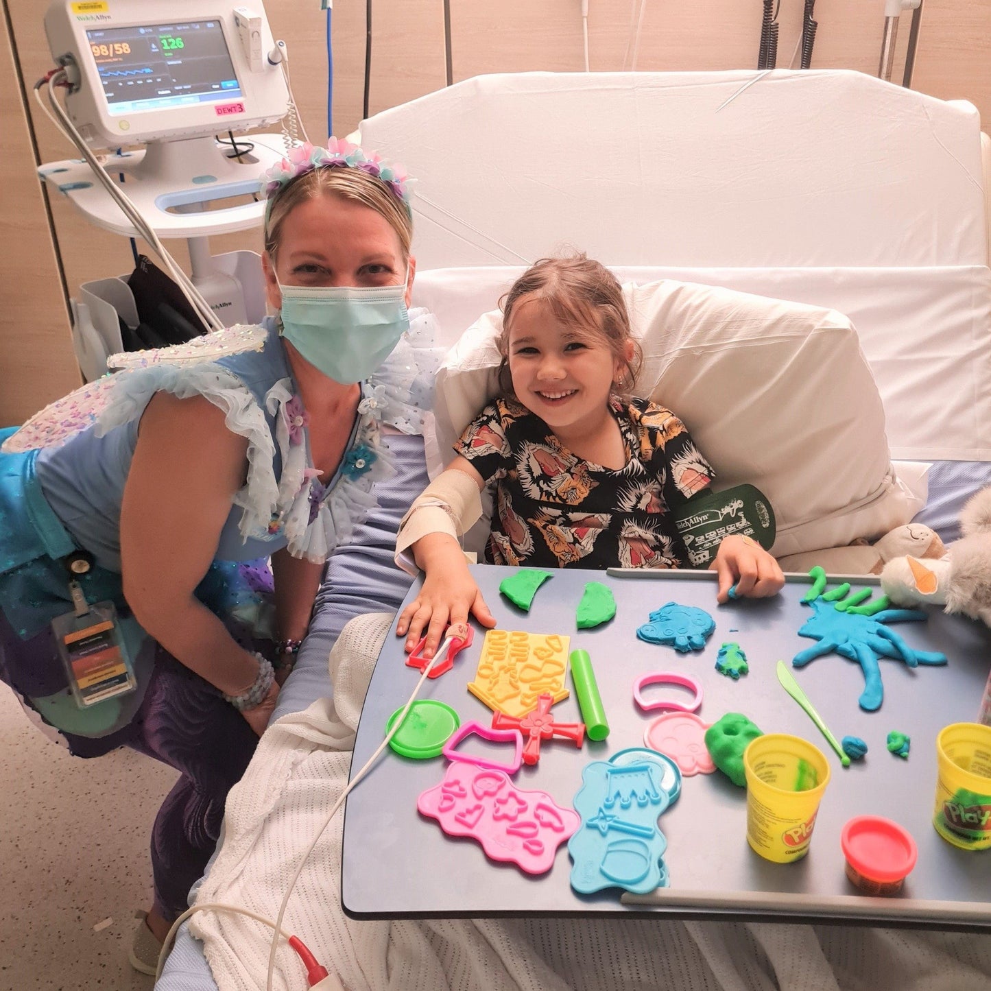 Fairy letter hospital visit – child enjoying playdough with visiting fairy